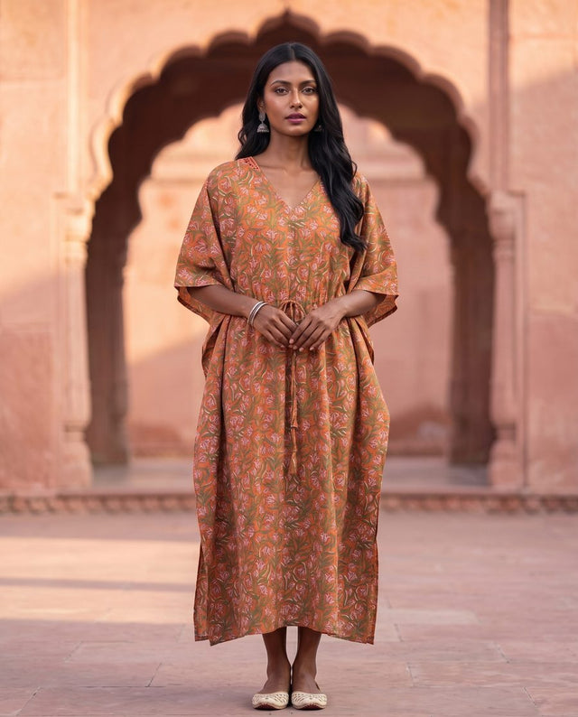 Front view of orange kaftan showing V-neck and drawstring waist tassels